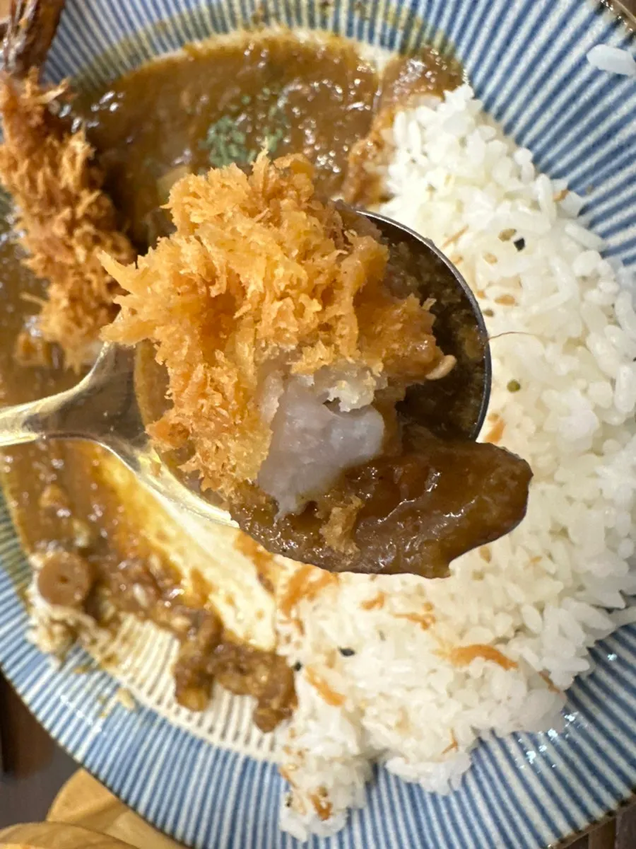 Close-up of the shrimp tempura on top of the curry