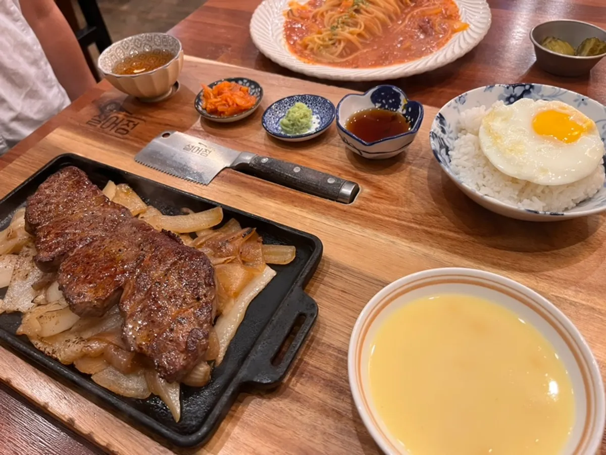 A piece of chuck flap steak with sauce and wasabi