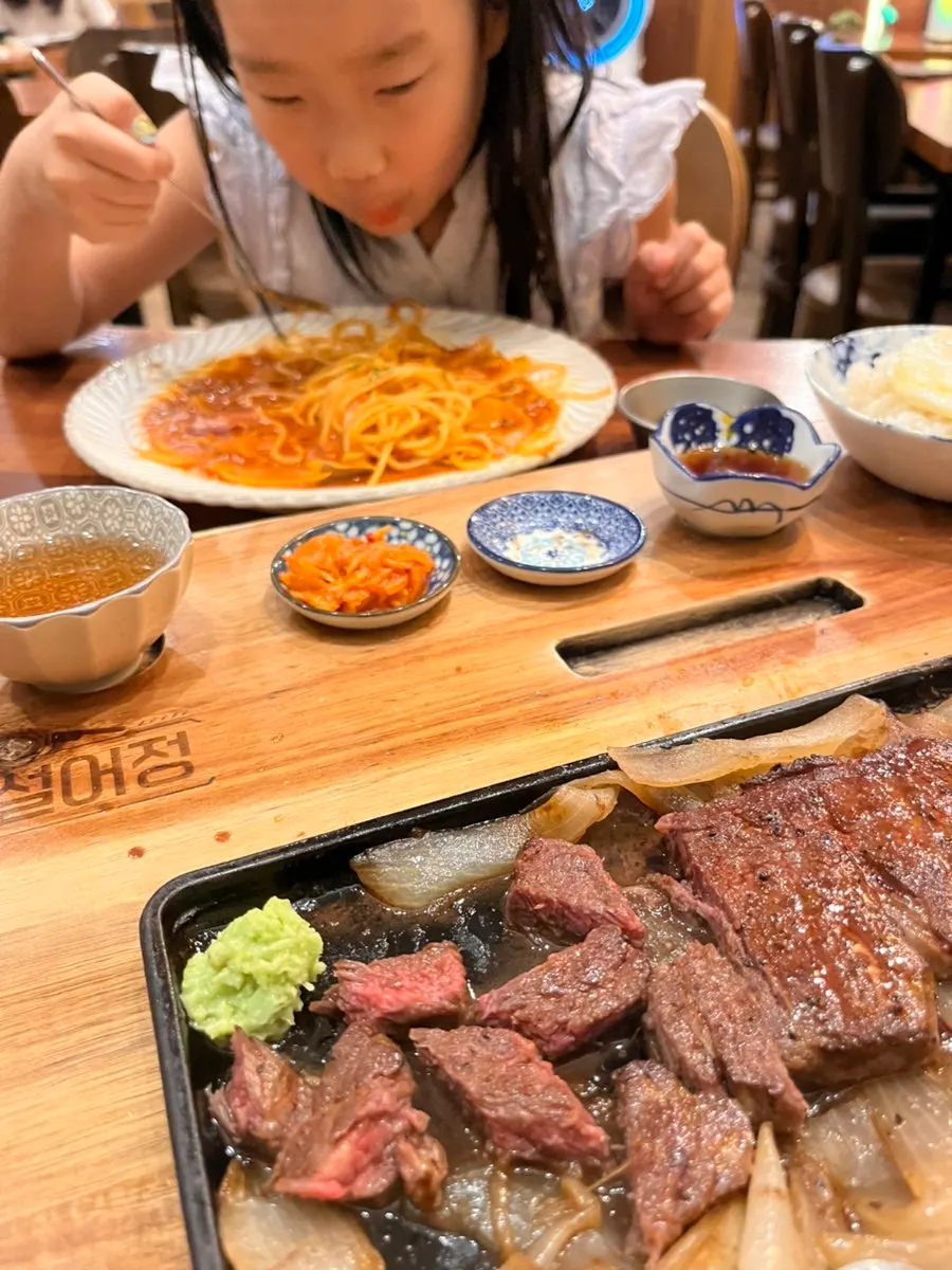 Chuck flap steak and tomato pasta served together on the table