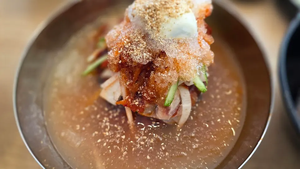 Naengmyeon and jjukkumi set together on the table