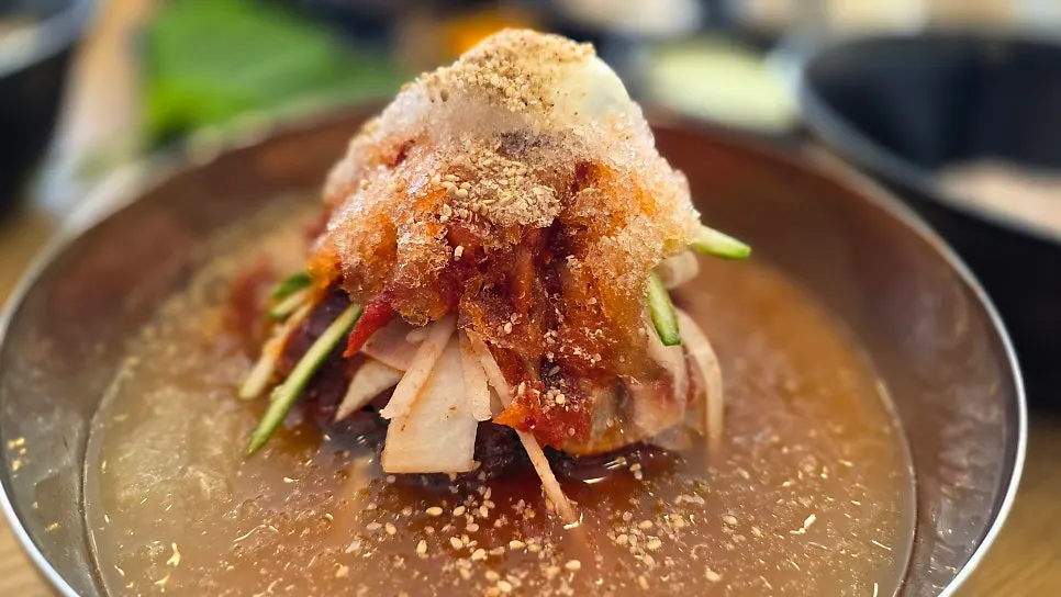 Bowl of naengmyeon topped with codari-hoe