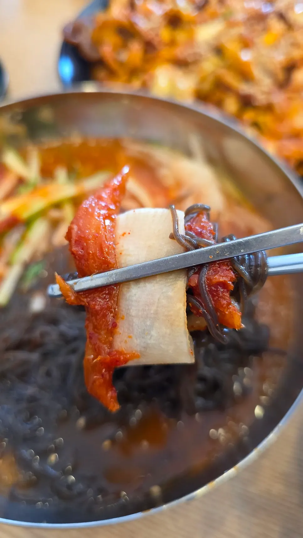 Noodles and radish picked up together with codari-hoemul bibim naengmyeon