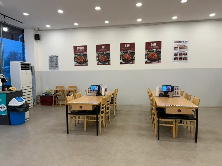 Spacious restaurant interior with tables set far apart