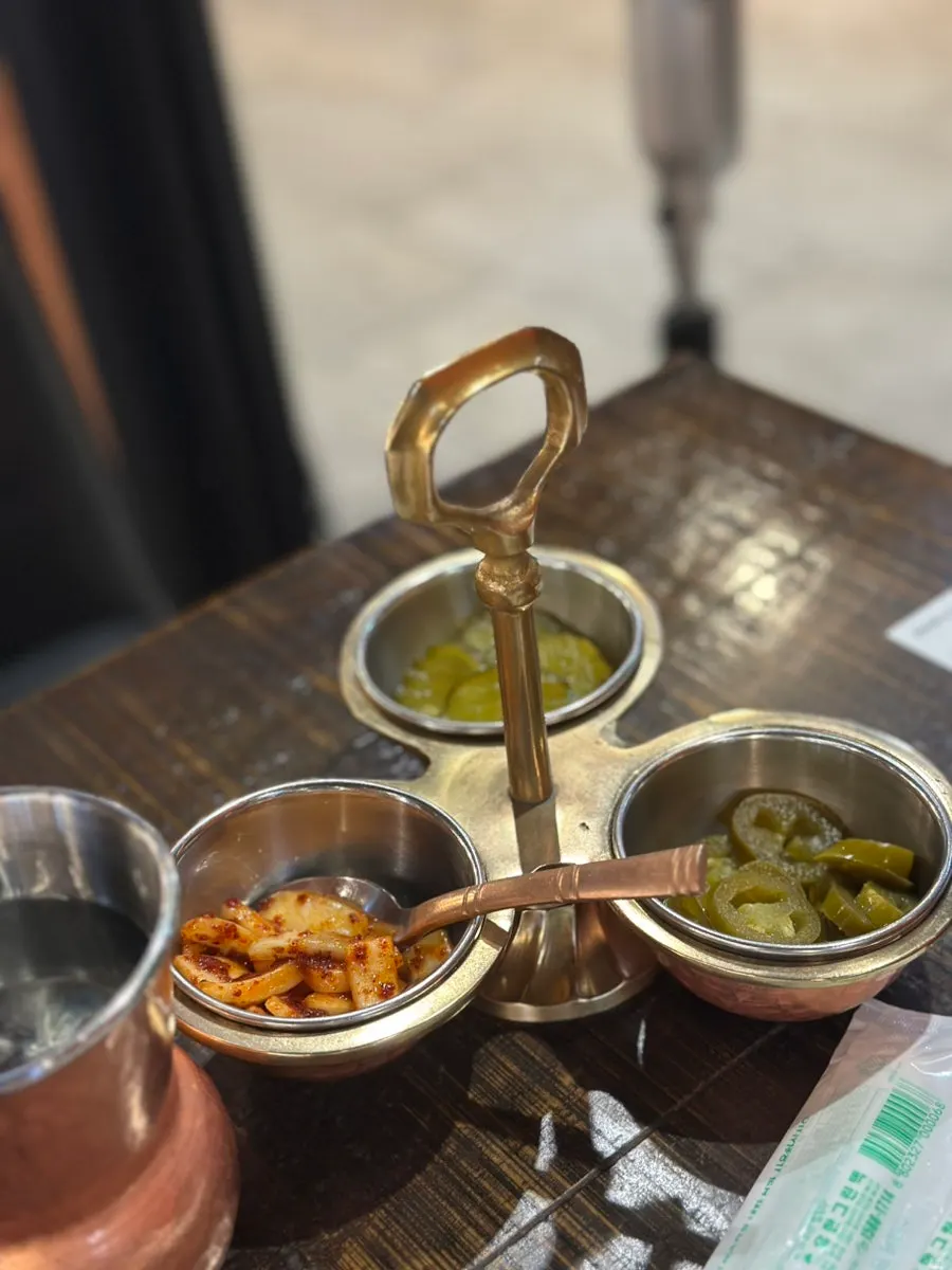 Plate of onion, pickles, and jalapeño side dishes