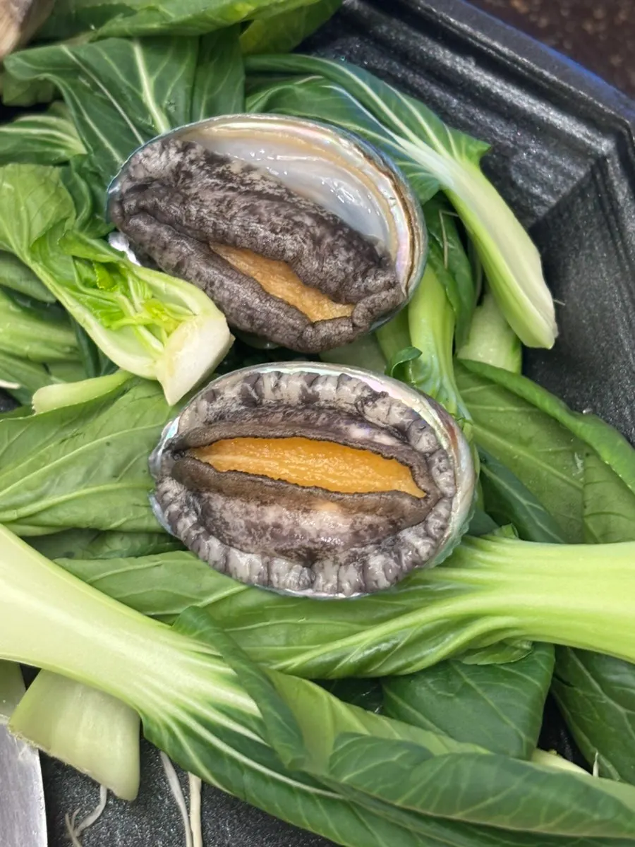 Abalone boiling in the seafood broth
