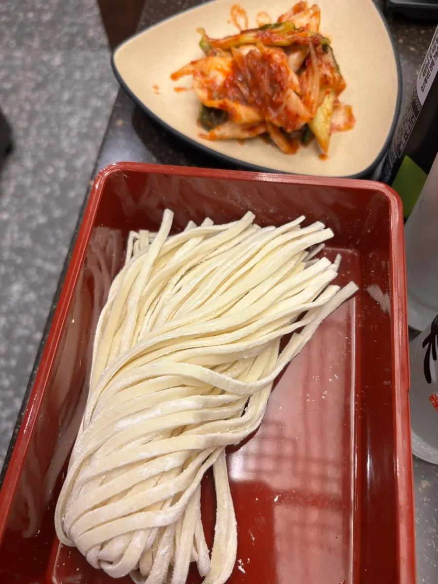 Seafood shabu-shabu broth at a rolling boil