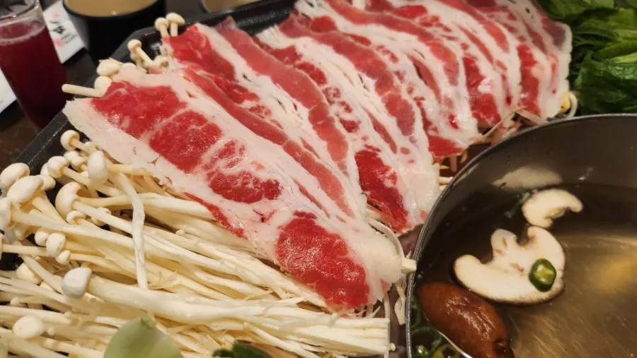 Pot of clam shabu filled with seafood and meat