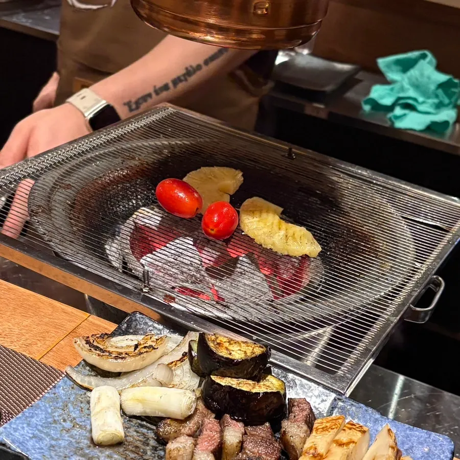Vegetables, mushrooms, and fruit grilled alongside the meat