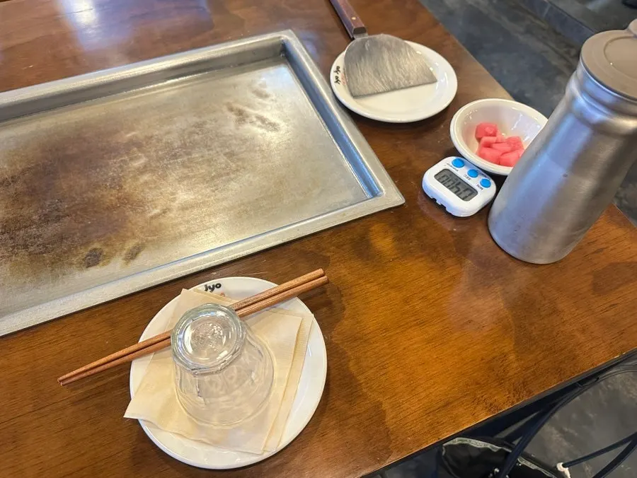 Sauces and bonito flakes set out on the table
