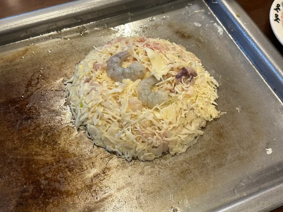 Jojo signature okonomiyaki on the griddle