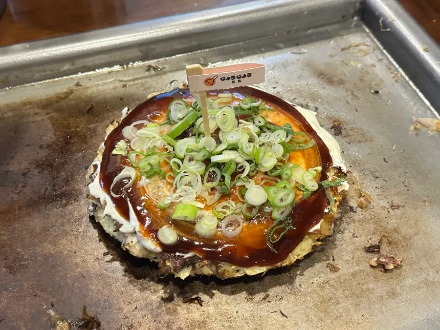 A piece of okonomiyaki cut and served