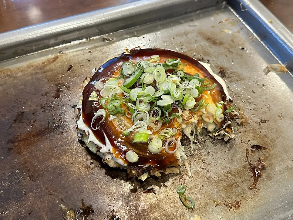 Okonomiyaki and mentaiko gyoza served together on the griddle