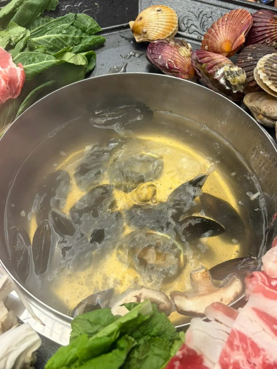 Pot simmering with mussels and abalone added first