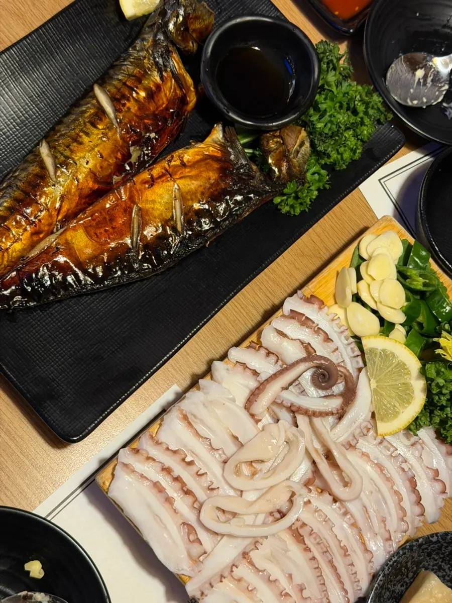 Plate of grilled mackerel with the flesh picked apart