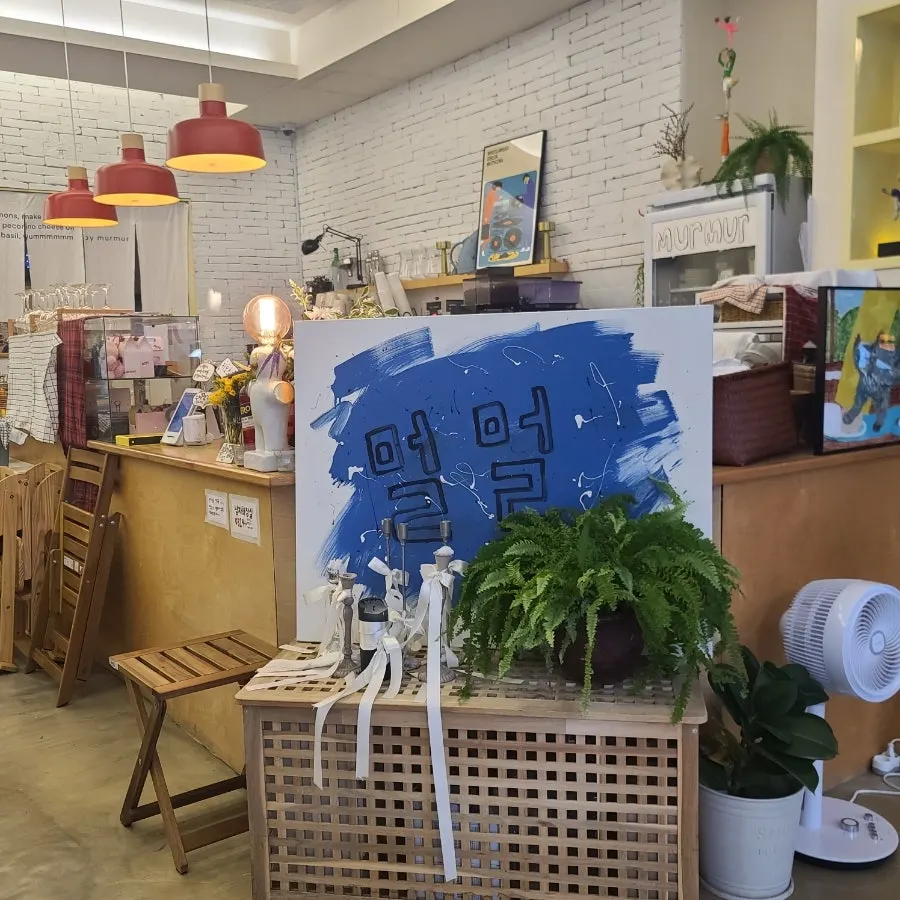 Interior of Meolmeol Pangyo with white exposed brick and wooden tables