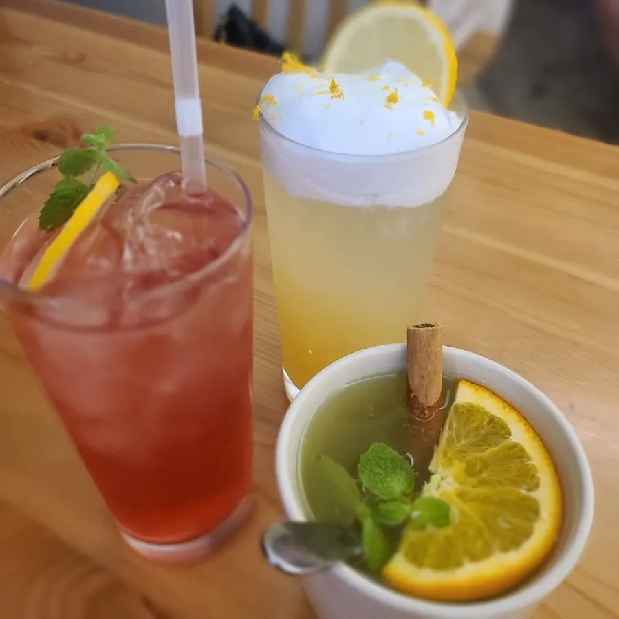 A lemon zest cream foam drink and a cinnamon-stick tea-ade