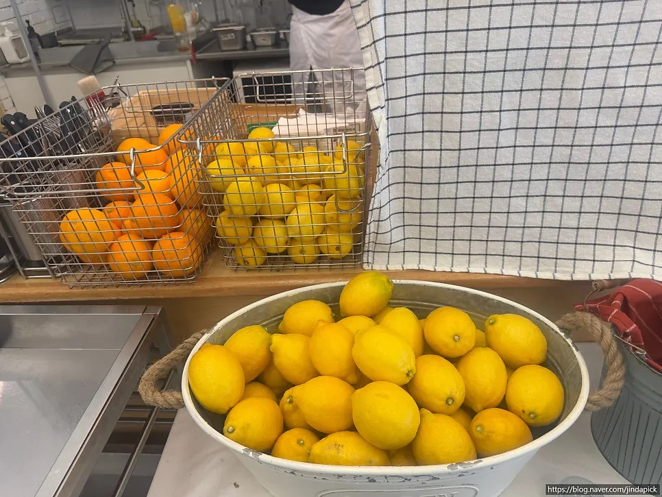 Self-serve bar with a water bottle full of lemons and oranges