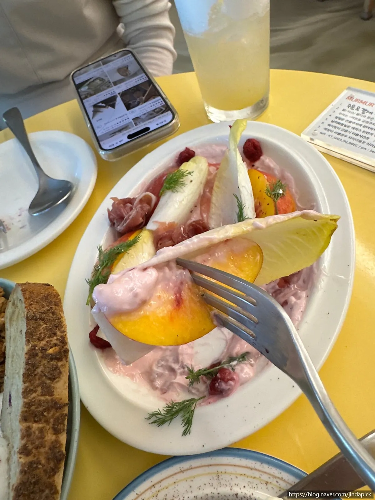Plate of endive salad over pink cream dressing