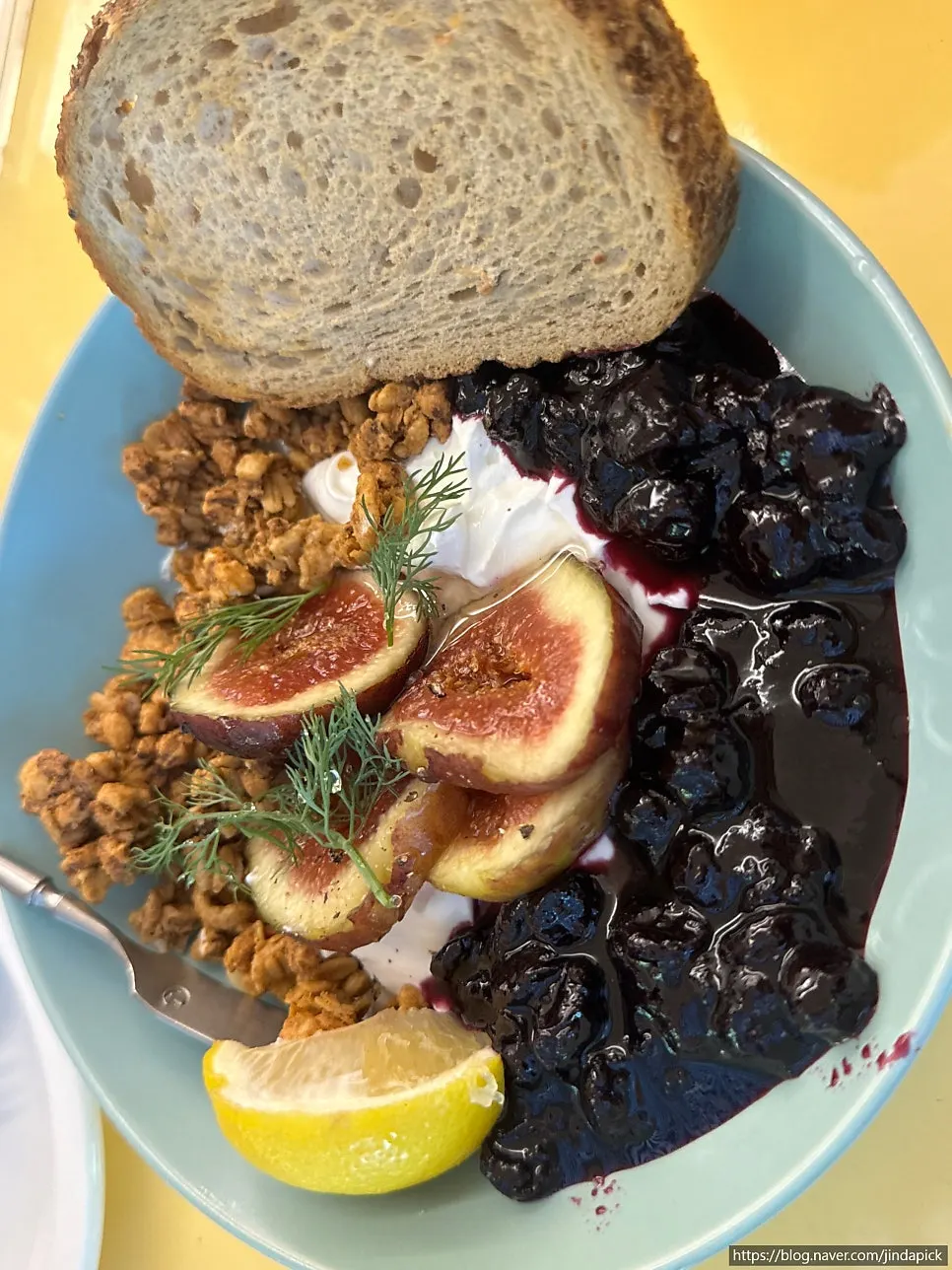 Greek yogurt bowl topped with roasted figs and blueberries
