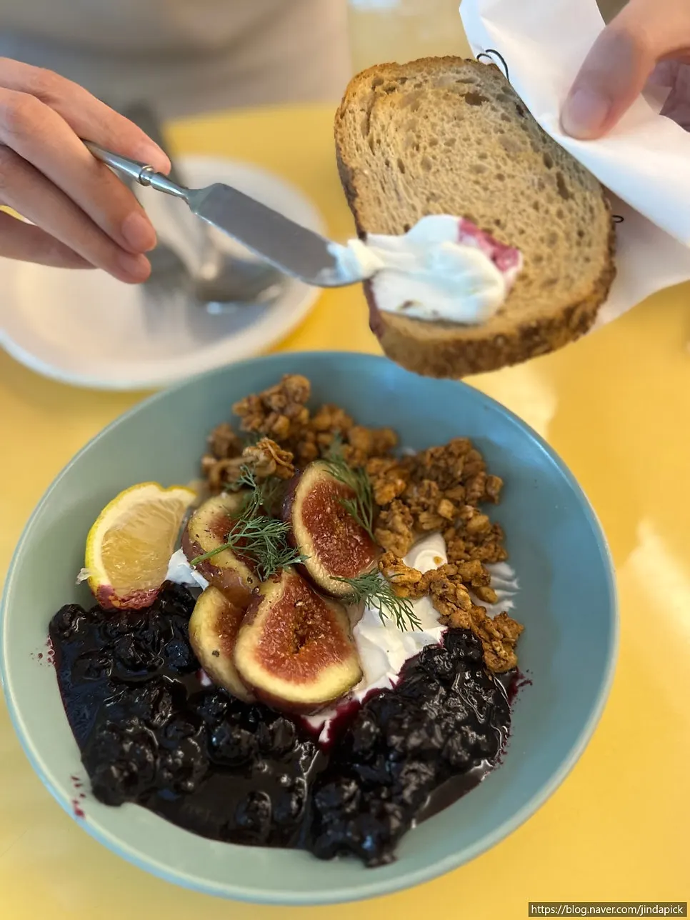 Greek yogurt bowl with granola and a lemon slice