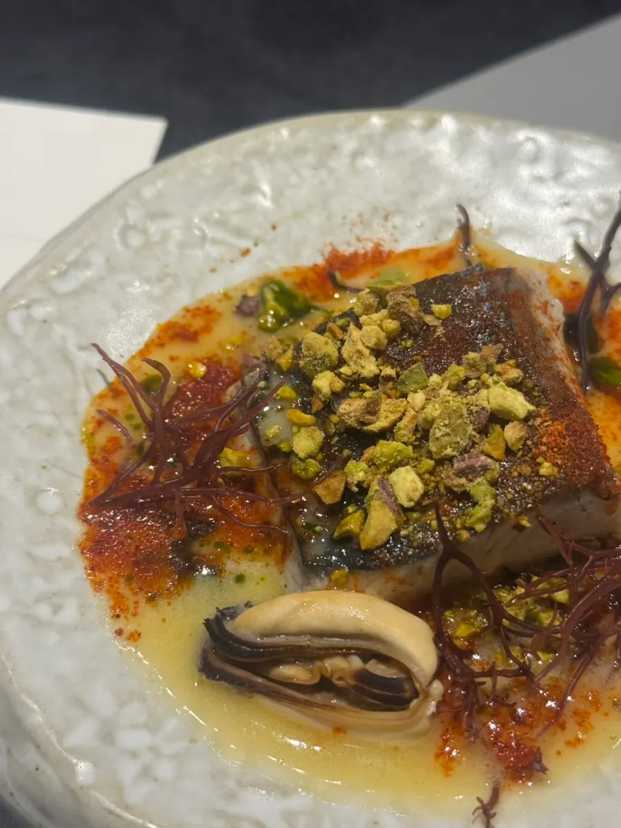 Close-up of the mackerel dish topped with pistachio