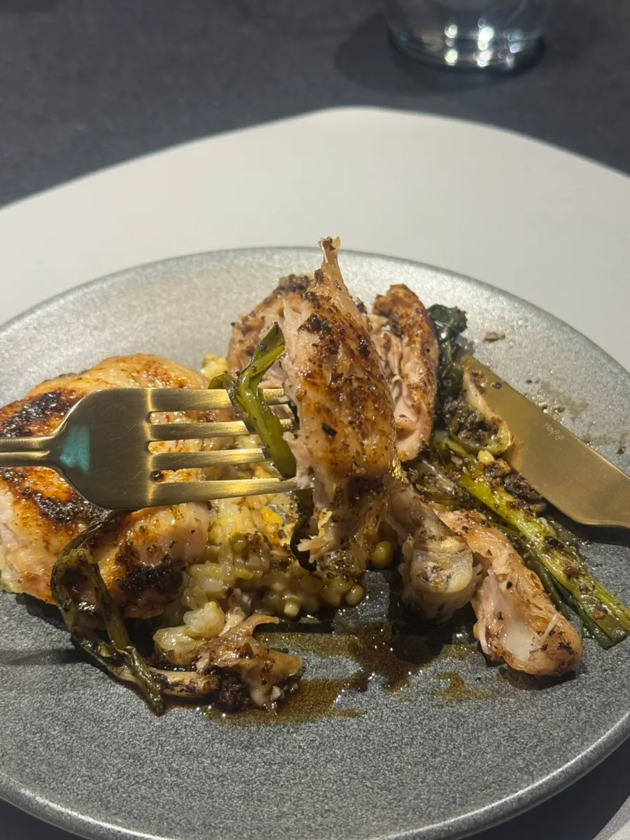 Chicken leg main dish served with pickled green onion