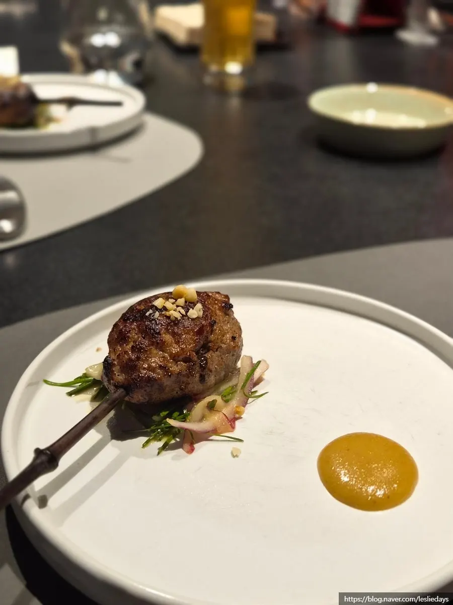 Tteokgalbi on a stick with pine nut mustard sauce