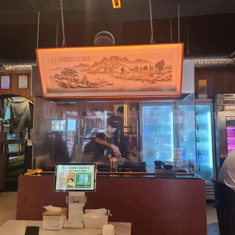 Interior atmosphere with staff grilling the meat for guests