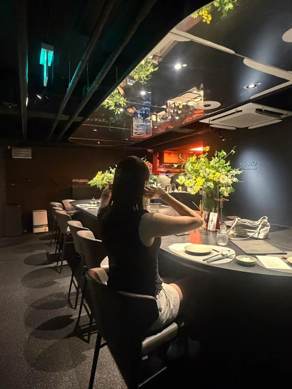 MUSEO's interior with low black-toned lighting