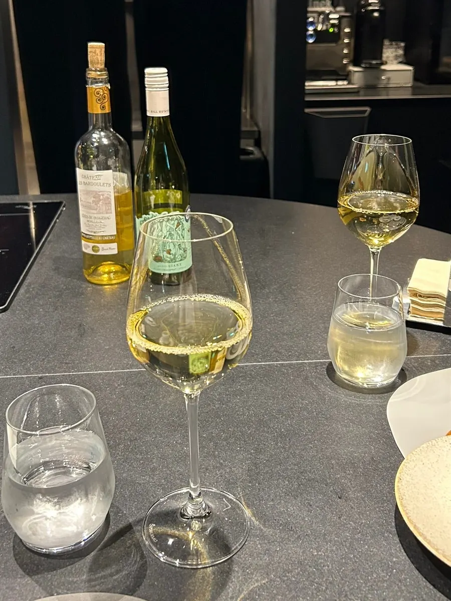 A glass of wine being served at MUSEO