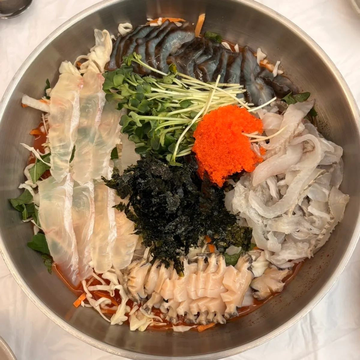 A bowl of mulhoe with abalone and raw fish