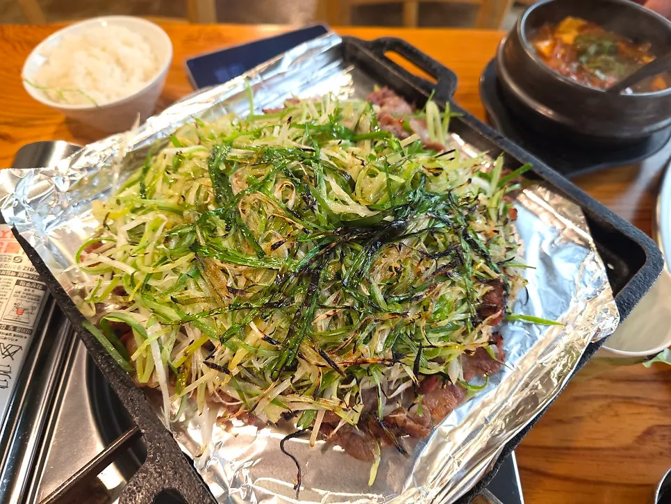 Staff member pre-grilling bulgogi over charcoal