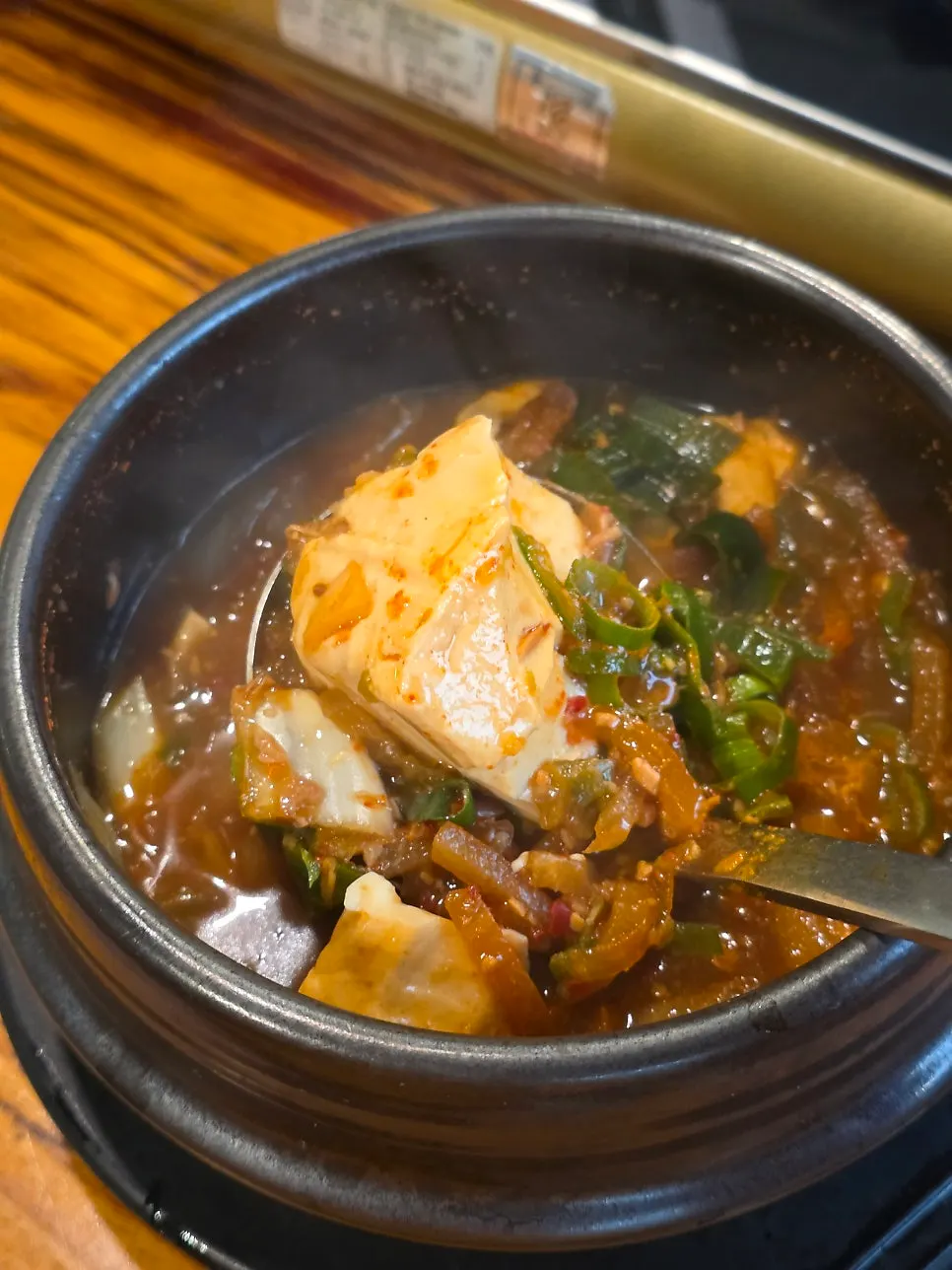 Piece of pajeon bulgogi placed on wrap greens