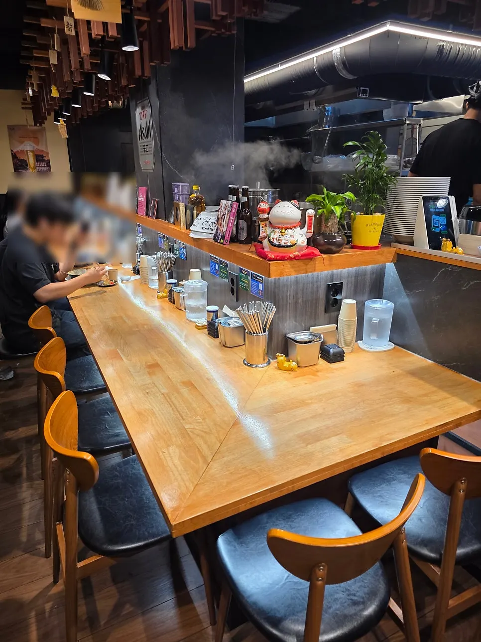 Ground-floor bar seating for solo diners at Mentsuru City Hall Branch