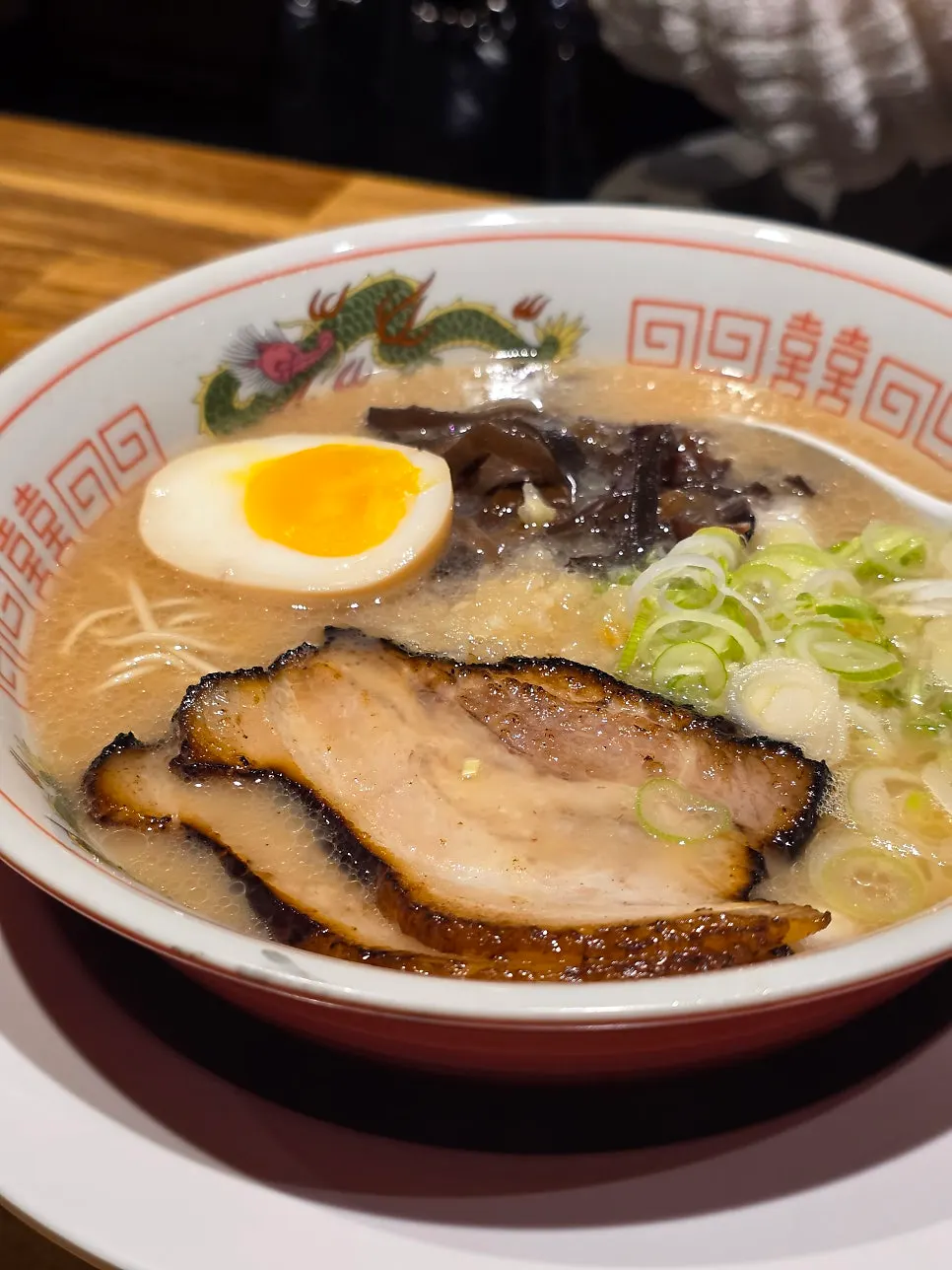 Close-up of tonkotsu ramen broth and toppings
