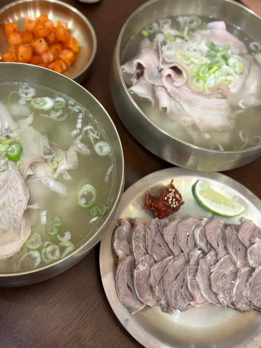 Baekok pork gomtang served in a brass bowl
