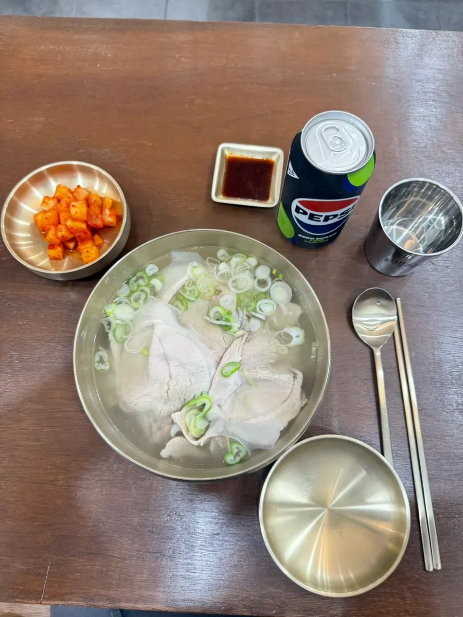 Pork gomtang topped with scallions and meat