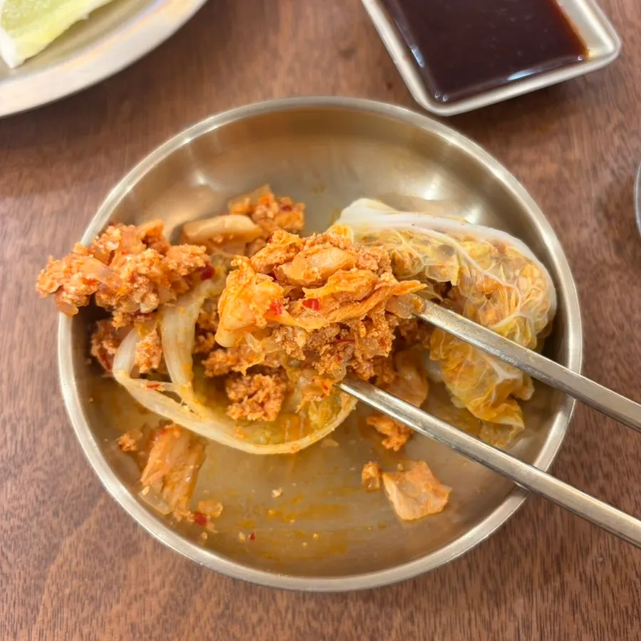 Cross-section of a cabbage dumpling showing kimchi-dumpling-style filling