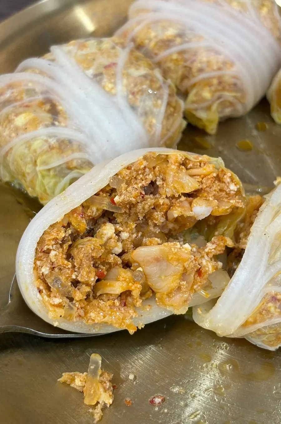 Cabbage dumpling cut in half showing kimchi filling