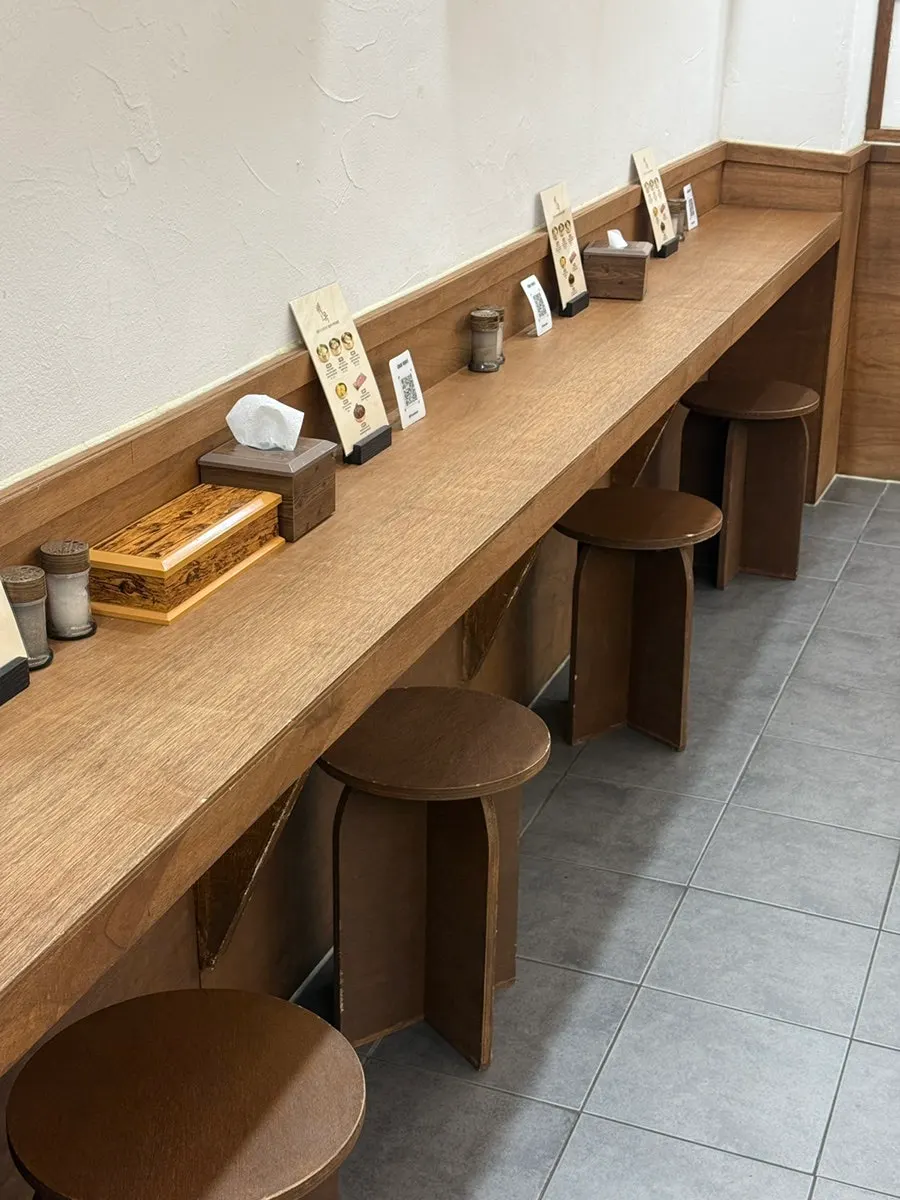 Solo dining seats facing the wall