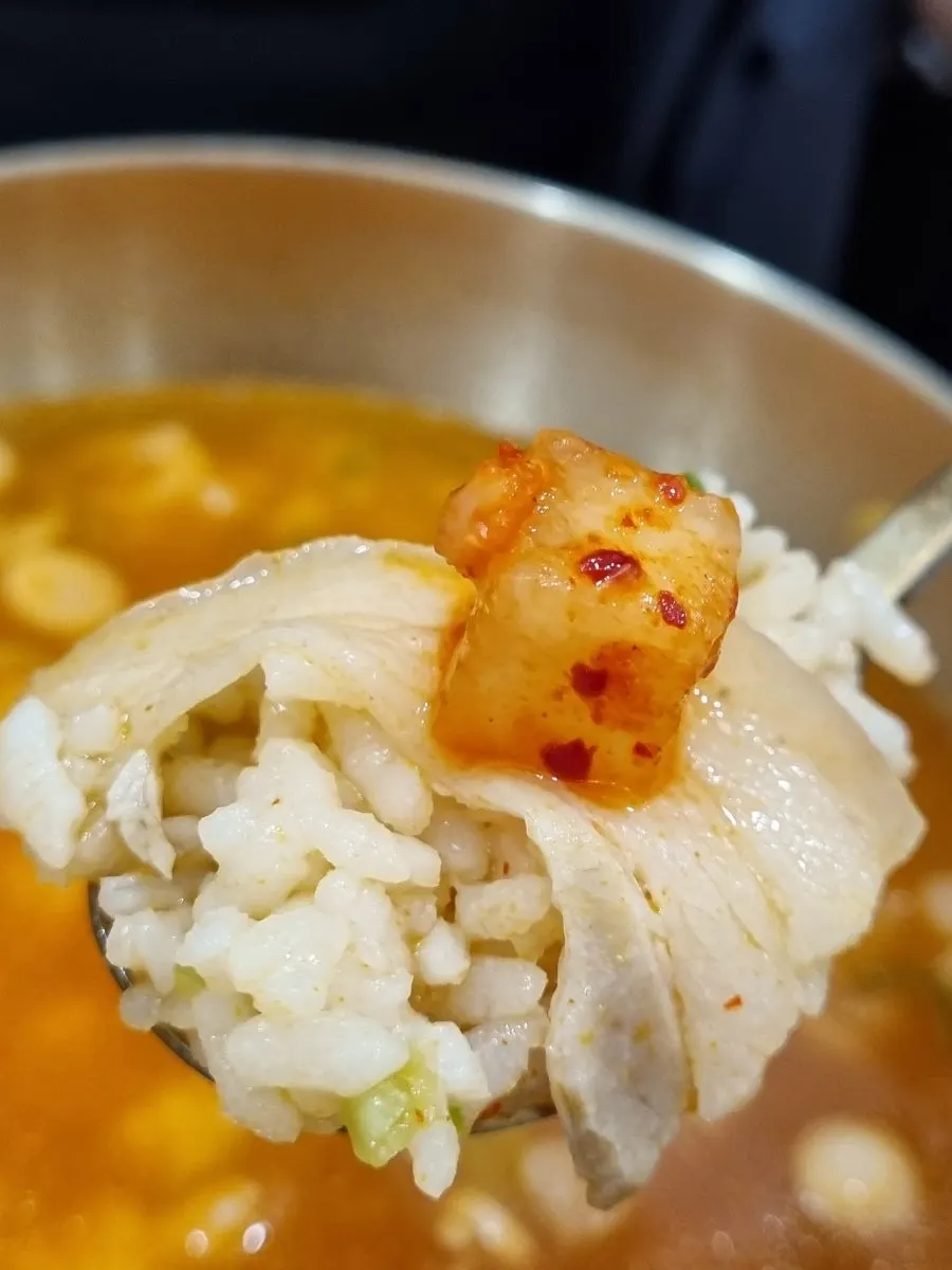 Spoonful of the spicy yeolgomtang broth