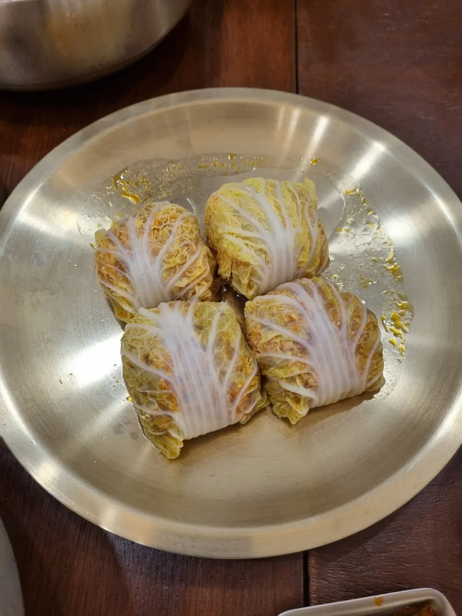Table setting with cabbage dumplings wrapped in cabbage leaves