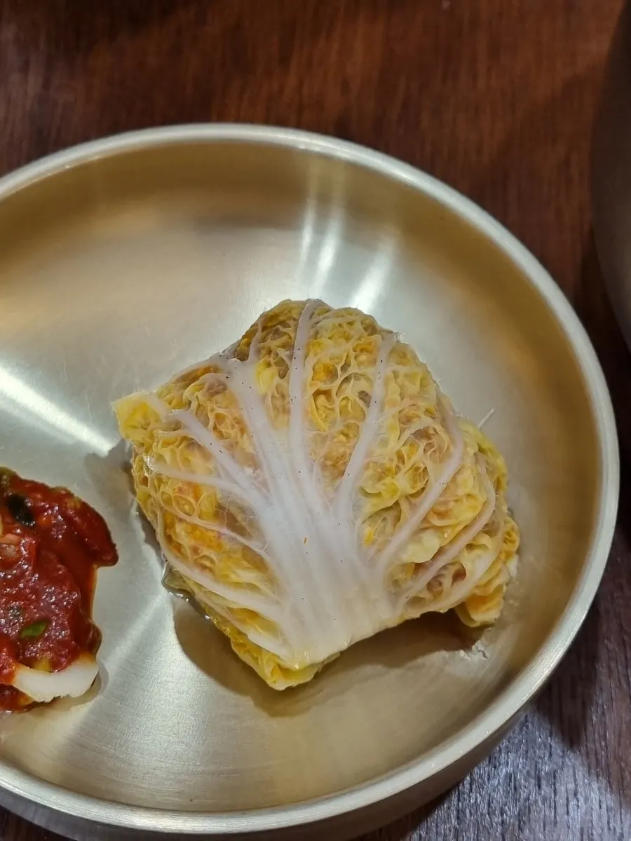 Cross-section of a cabbage dumpling with kimchi-meat filling