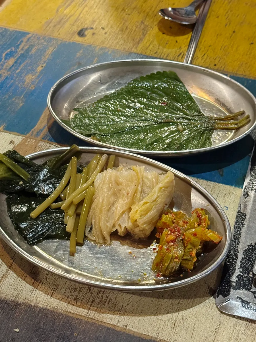Pickled garlic scapes, aged kimchi, and other basic side dishes