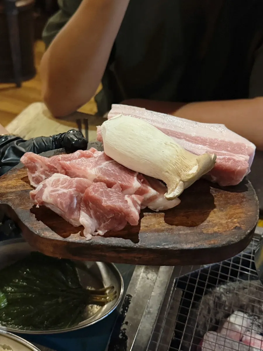 Black pork neck and belly placed on the grill