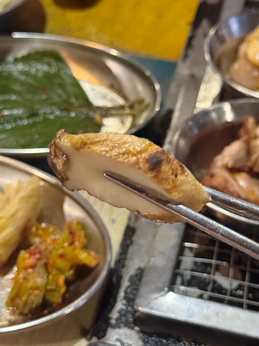 A piece of black pork dipped in salt and salted hairtail guts