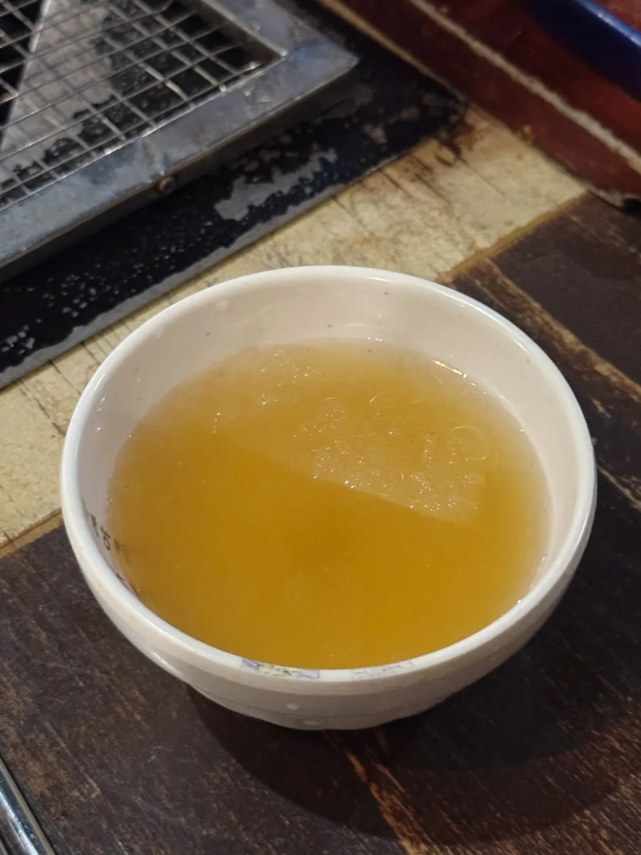 Broth poured into the bibim naengmyeon
