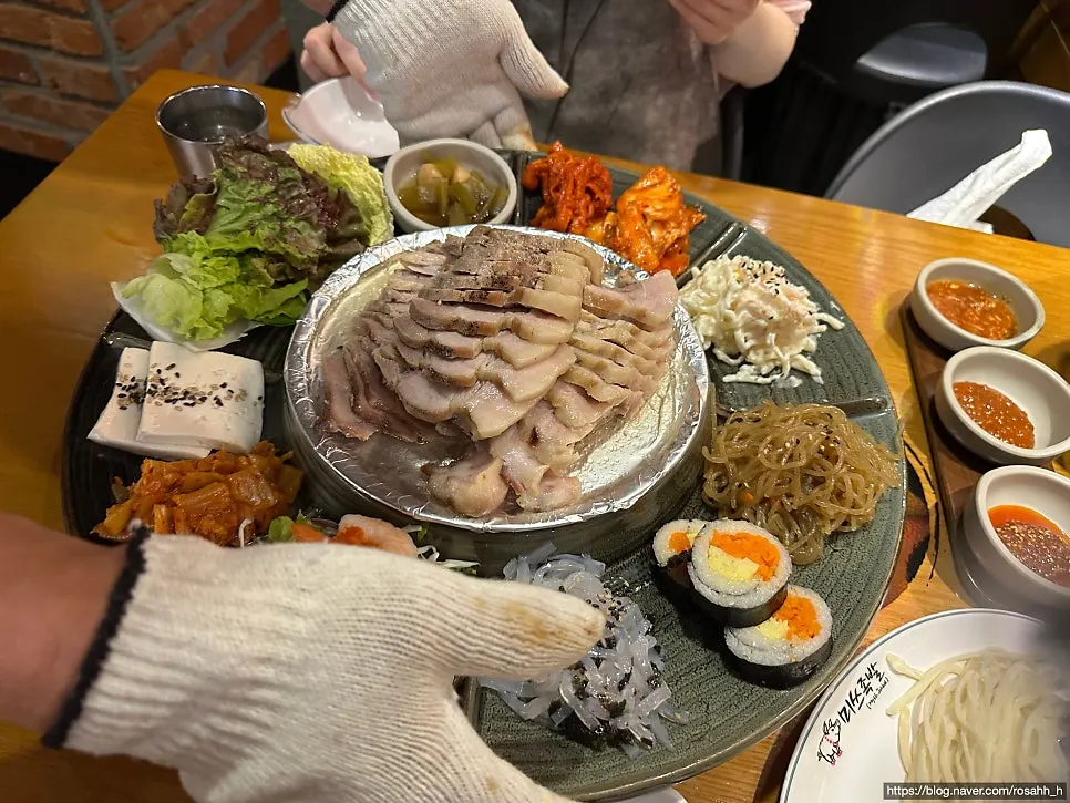 Bossam set surrounded by side dishes