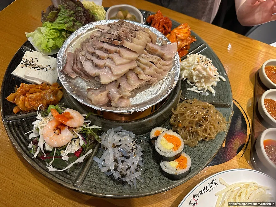Bossam set with wrapping vegetables, japchae noodles, and gimbap