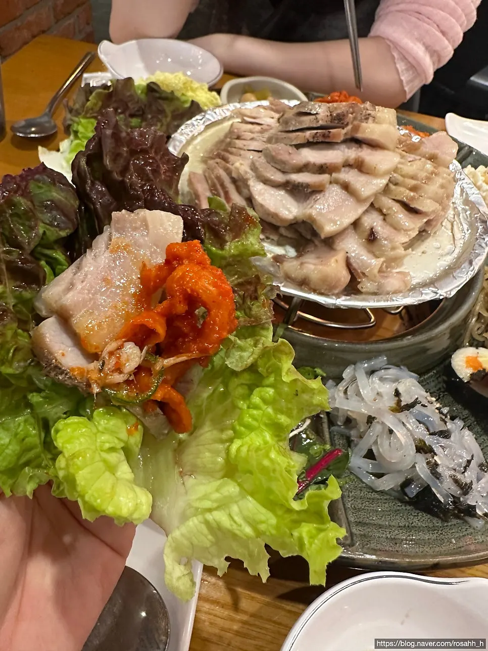 A bite of bossam wrapped in cabbage